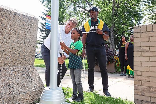 06082024
Brandon Mayor Jeff Fawcett and six-year-old Zurik Henlon raise the flag for Jamaica as Emelio Brown, President of the Westman Jamaican Community and Secretary Treasurer for the Brandon chamber of Commerce looks on during a celebration of the independence day of Jamaica at Brandon City Hall on Tuesday. Mayor Fawcett spoke about the importance of the community in Brandon and posed for photos with members of the community. (Tim Smith/The Brandon Sun)