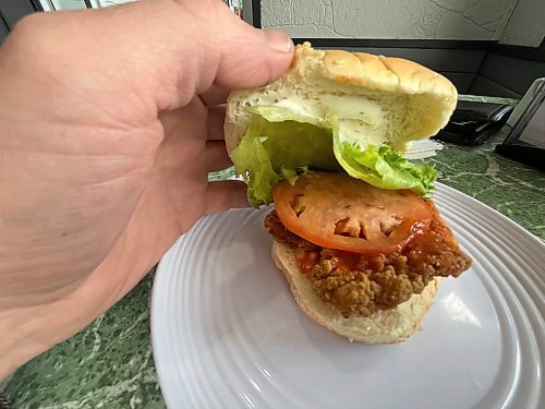 The buffalo chicken burger at Carberry's Summer Shack Drive In comes with lettuce, tomato, ranch and a slather of spicy sauce on a crispy fried chicken fillet. (Matt Goerzen/The Brandon Sun) 