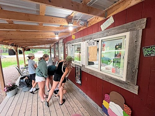 Customers wait outside the order window at CJ's Snack Shack and Mini Golf at Rivers Provincial Park on a warm Monday evening. (Matt Goerzen/The Brandon Sun)