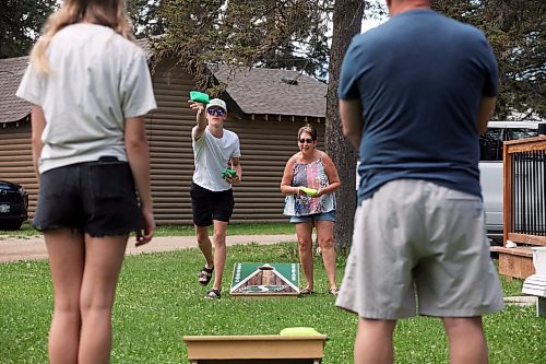 06082024
Connor Brady throws a beanbag while playing cornhole with his sister Lola and grandparents Alane and Brian Seeman in Wasagaming on a warm Wednesday afternoon.     (Tim Smith/The Brandon Sun) 