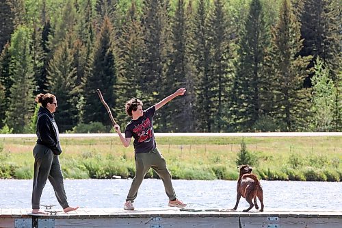 06082024
Aynsley Smith and her son Lev Webster throw a stick for their dog Buffy, a rescue from Funds For Furry Friends, from a dock on Clear Lake in Riding Mountain National Park on a warm Wednesday afternoon.     (Tim Smith/The Brandon Sun) 