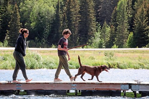 06082024
Aynsley Smith and her son Lev Webster throw a stick for their dog Buffy, a rescue from Funds For Furry Friends, from a dock on Clear Lake in Riding Mountain National Park on a warm Wednesday afternoon.     (Tim Smith/The Brandon Sun) 