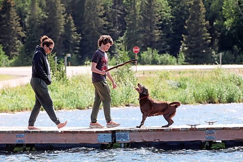 06082024
Aynsley Smith and her son Lev Webster throw a stick for their dog Buffy, a rescue from Funds For Furry Friends, from a dock on Clear Lake in Riding Mountain National Park on a warm Wednesday afternoon.     (Tim Smith/The Brandon Sun) 