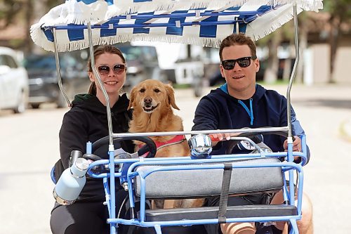 06082024
Britany Macovichuk and Jayden Nickel ride through Wasagaming in a family pedal bike along with Jayden&#x2019;s dog Penny on a warm Wednesday.     (Tim Smith/The Brandon Sun)