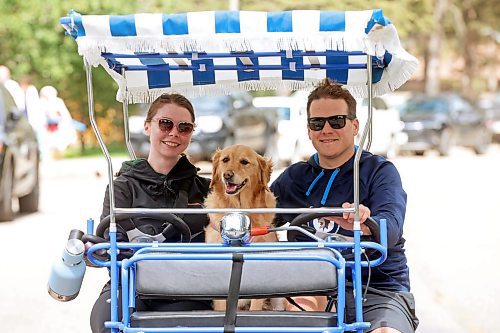 06082024
Britany Macovichuk and Jayden Nickel ride through Wasagaming in a family pedal bike along with Jayden&#x2019;s dog Penny on a warm Wednesday.     (Tim Smith/The Brandon Sun)