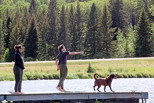 06082024
Aynsley Smith and her son Lev Webster throw a stick for their dog Buffy, a rescue from Funds For Furry Friends, from a dock on Clear Lake in Riding Mountain National Park on a warm Wednesday afternoon.     (Tim Smith/The Brandon Sun) 