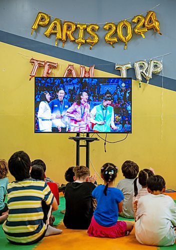 NIC ADAM / FREE PRESS
TRP Academy head instructor Steven Rivest and the gym&#x2019;s ages 5-9 summer camp watch Winnipegger Skylar Park receive her bronze medal at the 2024 Paris Olympics.
240808 - Thursday, August 08, 2024.

Reporter: ?