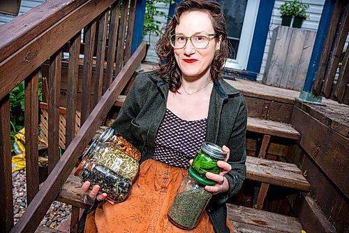 NIC ADAM / FREE PRESS
Local artist Ash Alberg, pictured outside her home Thursday, with jars full of dying materials she made with plants from her garden. 
240808 - Thursday, August 08, 2024.

Reporter: Maggie