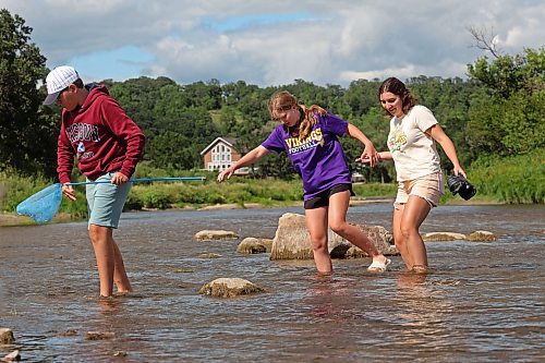 Siblings Mikkel, Azaliah and Violet MacLellan explore the Little Saskatchewan River with family on Thursday. (Tim Smith/The Brandon Sun)