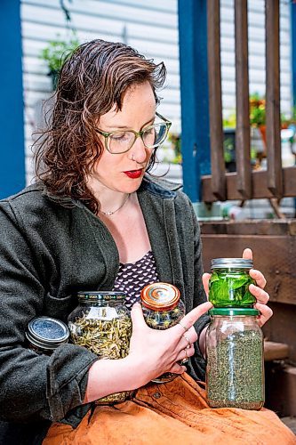 NIC ADAM / FREE PRESS
Local artist Ash Alberg, pictured outside her home Thursday, with jars full of dying materials she made with plants from her garden. 
240808 - Thursday, August 08, 2024.

Reporter: Maggie