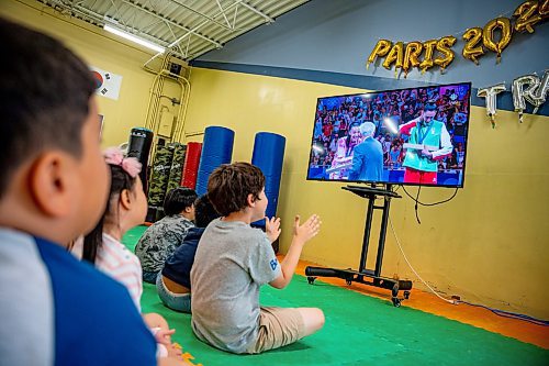 NIC ADAM / FREE PRESS
TRP Academy head instructor Steven Rivest and the gym&#x2019;s ages 5-9 summer camp watch Winnipegger Skylar Park receive her bronze medal at the 2024 Paris Olympics.
240808 - Thursday, August 08, 2024.

Reporter: ?