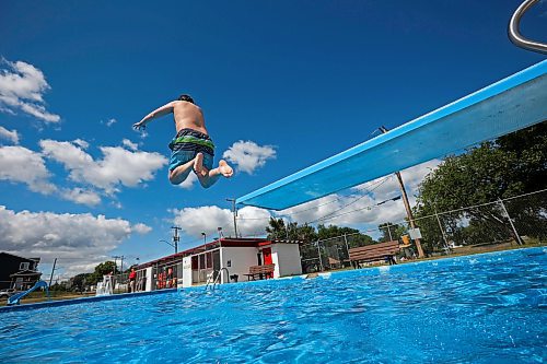 08082024
Karter Henderson leaps off the diving board at the Kinsmen Centennial Pool in Brandon&#x2019;s Rideau Park while swimming with his cousin Leland Henderson on a windy Thursday.  
(Tim Smith/The Brandon Sun)