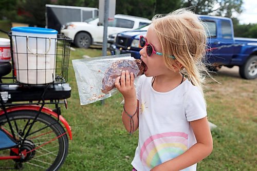 08082024
Gabriella Korban enjoys an ice-cream taco while the Korban family from Rossburn enjoys Sandy Lake Western Days at Sandy Lake, Manitoba on Friday. Western Days runs until Sunday with a variety of town events and entertainment. 
(Tim Smith/The Brandon Sun)