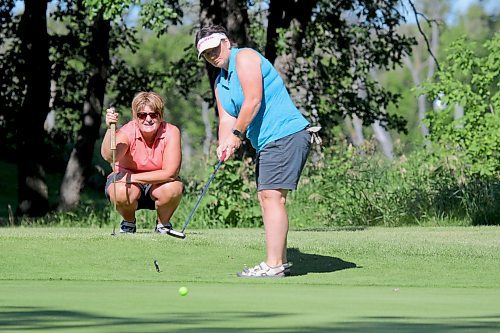 Carolyn Hardy putts from the fringe on the 12th hole while teammate Carla Richardson gets a read. They lagged it to four feet and drained the next one, en route to a 2-under 70 to win the Ladies Western Scramble at Wheat City Golf Course by two strokes on a sunny Sunday. (Thomas Friesen/The Brandon Sun)