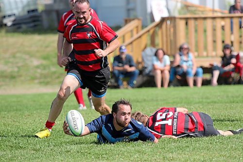 Brandon Barbarians scrum-half Kade Turnbull offloads the ball as he's being tackled during Brandon's 52-12 win over the Dauphin Mavericks in Rugby Manitoba men's Division 2 action at John Reilly Field on Saturday. (Thomas Friesen/The Brandon Sun)