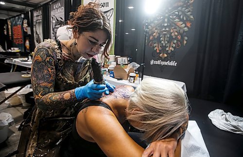 JOHN WOODS / FREE PRESS
Sheri Coburn from Saint John, New Brunswick gets a tattoo from Catlyne Favle of Lucky Toad Tattoo from Duncan during the Winnipeg Tattoo Convention at Red River Exhibition Park Sunday, August 11, 2024. More than 250 tattoo artists from around the globe came together to practice their craft. Coburn came all the way from New Brunswick to get inked by Favle.

Reporter: ?