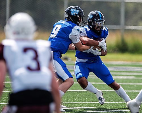 JOHN WOODS / FREE PRESS
Winnipeg Rifles quarterback Myles Desmarais (9) hands off to Kaiden Banfield (34) against Regina Thunder during first half CJFL action in Winnipeg Sunday, August 11, 2024. 

Reporter: josh