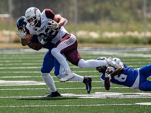 JOHN WOODS / FREE PRESS
Winnipeg Rifles&#x2019; Kyler Banfield (4) tackles Regina Thunder&#x2019;s Ryland Leichert (32) during first half CJFL action in Winnipeg Sunday, August 11, 2024. 

Reporter: josh