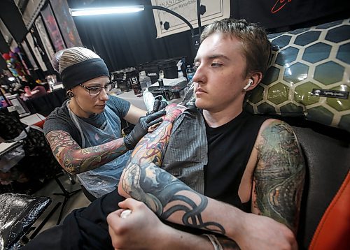 JOHN WOODS / FREE PRESS
Ashton Lutz gets a tattoo from Anastasia Powell of Beehaven Ink in Edmonton during the Winnipeg Tattoo Convention at Red River Exhibition Park Sunday, August 11, 2024. More than 250 tattoo artists from around the globe came together to practice their craft.

Reporter: ?