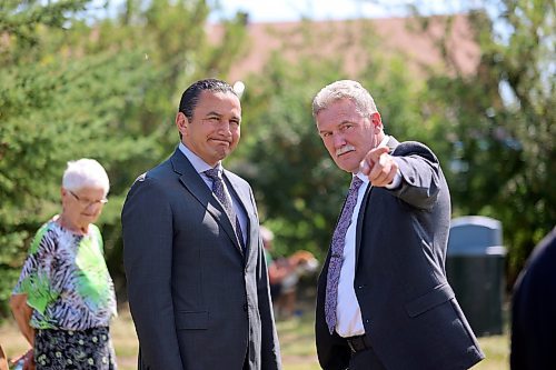 Carberry Mayor Raymond Muirhead points out a person in the crowd to Manitoba Premier Wab Kinew before a memorial unveiling ceremony at Carberry on Sunday afternoon. (Abiola Odutola/The Brandon Sun) 