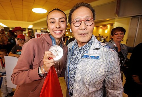 JOHN WOODS / FREE PRESS
Skylar Park, Olympic bronze medalist in taekwondo, shows off her medal with her grandfather Grandmaster Duek Hwa Park as she arrives at the Winnipeg airport as she returns from Paris Monday, August 12, 2024. 

Reporter: ken