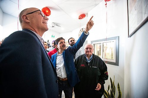 MIKAELA MACKENZIE / FREE PRESS

	
Duffy&#x573; Taxi general manager Ram Valluru points out historical photos to mayor Scott Gillingham at the ribbon-cutting for Duffy&#x573; Taxi&#x573; new building on Notre Dame on Monday, Aug. 12, 2024.

For Aaron Epp story.