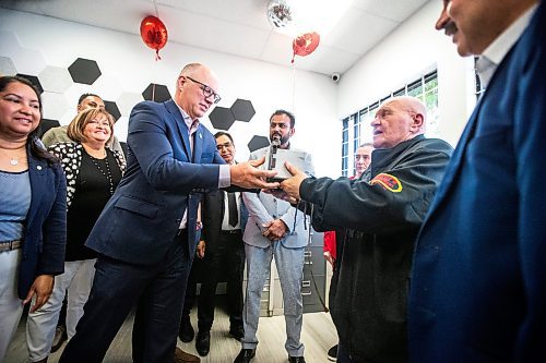 MIKAELA MACKENZIE / FREE PRESS

	
Duffy&#x573; Taxi road supervisor Barry Homenick hands mayor Scott Gillingham an original taxi meter at the ribbon-cutting for Duffy&#x573; Taxi&#x573; new building on Notre Dame on Monday, Aug. 12, 2024.

For Aaron Epp story.