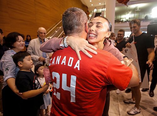 JOHN WOODS / FREE PRESS
Skylar Park, Olympic bronze medalist in taekwondo, hugs supporters as she arrives at the Winnipeg airport as she returns from Paris Monday, August 12, 2024. 

Reporter: ken