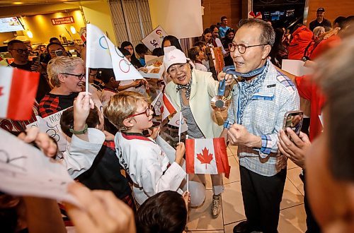 JOHN WOODS / FREE PRESS
Skylar Park, Olympic bronze medalist in taekwondo, grandmother Kyung Ja Park and grandfather Grandmaster Duek Hwa Park show her medal to children as she arrives at the Winnipeg airport as she returns from Paris Monday, August 12, 2024. 

Reporter: ken