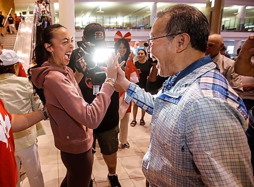 JOHN WOODS / FREE PRESS
Skylar Park, Olympic bronze medalist in taekwondo, hi-fives her grandfather Grandmaster Duek Hwa Park as she arrives at the Winnipeg airport as she returns from Paris Monday, August 12, 2024. 

Reporter: ken