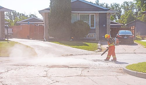 NIC ADAM / FREE PRESS
Workers from City Works repair Julien Pl. in St. Norbert after residents resorted to patching a section on their own after spending two years contacting the city. The section of street reportedly had rebar showing and was causing issues with vehicles and children&#x2019;s bicycles.
240813 - Tuesday, August 13, 2024.

Reporter: Tyler