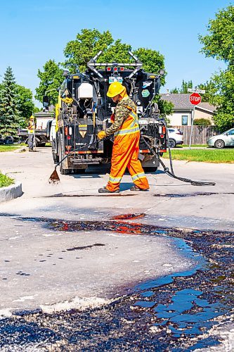 NIC ADAM / FREE PRESS
Workers from City Works repair Julien Pl. in St. Norbert after residents resorted to patching a section on their own after spending two years contacting the city. The section of street reportedly had rebar showing and was causing issues with vehicles and children&#x2019;s bicycles.
240813 - Tuesday, August 13, 2024.

Reporter: Tyler