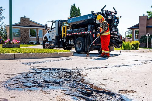 NIC ADAM / FREE PRESS
Workers from City Works repair Julien Pl. in St. Norbert after residents resorted to patching a section on their own after spending two years contacting the city. The section of street reportedly had rebar showing and was causing issues with vehicles and children&#x2019;s bicycles.
240813 - Tuesday, August 13, 2024.

Reporter: Tyler