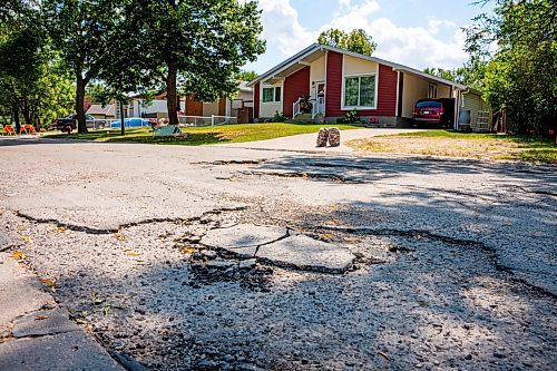 NIC ADAM / FREE PRESS
Potholes plague Augusta dr. in Waverley Heights pictured Tuesday afternoon. 
240813 - Tuesday, August 13, 2024.

Reporter: ?