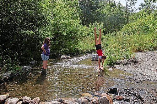 13082023
Best friends Georgia Richards and Myah LeBoutillier play in the shale creek at Big Valley northwest of Neepawa after a picnic with Richards brother and grandmother on Tuesday afternoon.
(Tim Smith/The Brandon Sun)