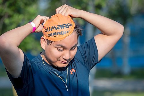 BROOK JONES / FREE PRESS
Phoenix Abraham, 15, who is from Sagkeeng First Nation, puts on his swim cap moments before the start of the Free Spirit Sprint Triathlon in Pinawa, Man., Sunday, Aug. 11, 2024.