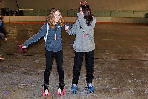 Athena Ringland and Leah Thurston roller-skate during Roller Disco at the Sportsplex Arena on Thursday evening. (Tim Smith/The Brandon Sun)