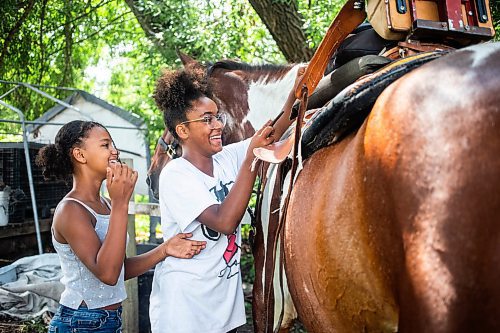 MIKAELA MACKENZIE / FREE PRESS

	
Raelene Husbands (left, 12) and Moriah Hector (13) saddle Duke with Alyssa Selman&#x573; customized rig on Tuesday, Aug. 13, 2024.

For Mike McIntyre story.