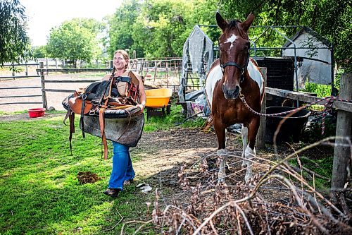 MIKAELA MACKENZIE / FREE PRESS

	
Amy Scott takes Alyssa Selman&#x573; customized saddle off of Duke on Tuesday, Aug. 13, 2024.

For Mike McIntyre story.