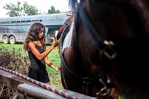 MIKAELA MACKENZIE / FREE PRESS

	
Ari Selman tries fo figure out how to best make a back cinch work for her mom&#x573; customized saddle on Duke on Tuesday, Aug. 13, 2024.

For Mike McIntyre story.