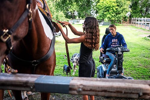 MIKAELA MACKENZIE / FREE PRESS

	
Ari Selman (left) and her mom, Alyssa Selman, try to figure out how to best make a back cinch work with Alyssa&#x573; customized saddle on Duke on Tuesday, Aug. 13, 2024.

For Mike McIntyre story.