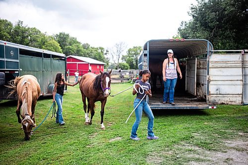 MIKAELA MACKENZIE / FREE PRESS

	
Ari Selman (left), Raelene Husbands, and Amy Scott load the horses into trailers to go to the races on Tuesday, Aug. 13, 2024.

For Mike McIntyre story.