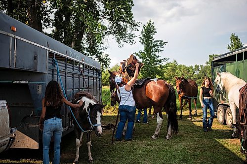 MIKAELA MACKENZIE / FREE PRESS

	
Amy Scott saddles Alyssa&#x573; horse, Duke, at the Denim &amp; Dust Barrel Racing Series in Carman on Tuesday, Aug. 13, 2024.

For Mike McIntyre story.