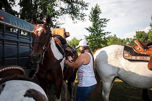 MIKAELA MACKENZIE / FREE PRESS

	
Amy Scott saddles Alyssa&#x573; horse, Duke, at the Denim &amp; Dust Barrel Racing Series in Carman on Tuesday, Aug. 13, 2024.

For Mike McIntyre story.