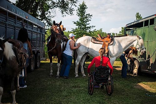 MIKAELA MACKENZIE / FREE PRESS

	
Amy Scott helps her sister Alyssa Selman get up into her saddle before warming up at the Denim &amp; Dust Barrel Racing Series in Carman on Tuesday, Aug. 13, 2024.

For Mike McIntyre story.