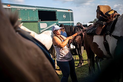 MIKAELA MACKENZIE / FREE PRESS

	
Amy Scott saddles Alyssa&#x573; horse, Duke, at the Denim &amp; Dust Barrel Racing Series in Carman on Tuesday, Aug. 13, 2024.

For Mike McIntyre story.