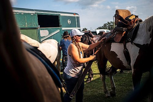 MIKAELA MACKENZIE / FREE PRESS

	
Amy Scott saddles Alyssa&#x573; horse, Duke, at the Denim &amp; Dust Barrel Racing Series in Carman on Tuesday, Aug. 13, 2024.

For Mike McIntyre story.