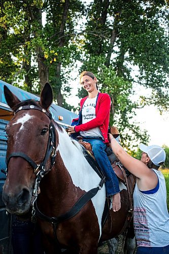 MIKAELA MACKENZIE / FREE PRESS

	
Amy Scott helps her sister Alyssa Selman get up into her saddle before competing at the Denim &amp; Dust Barrel Racing Series in Carman on Tuesday, Aug. 13, 2024.

For Mike McIntyre story.