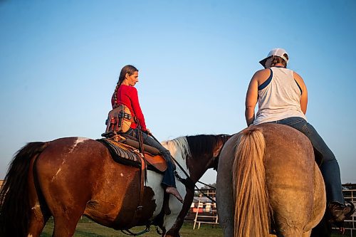 MIKAELA MACKENZIE / FREE PRESS

	
Alyssa Selman (left) and her sister, Amy Scott, watch the open races before Alyssa competes at the Denim &amp; Dust Barrel Racing Series in Carman on Tuesday, Aug. 13, 2024.

For Mike McIntyre story.