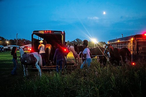 MIKAELA MACKENZIE / FREE PRESS

	
Alyssa sister, Amy Scott, loads the horses back in to the trailers as the moon rises after the Denim &amp; Dust Barrel Racing Series in Carman on Tuesday, Aug. 13, 2024.

For Mike McIntyre story.